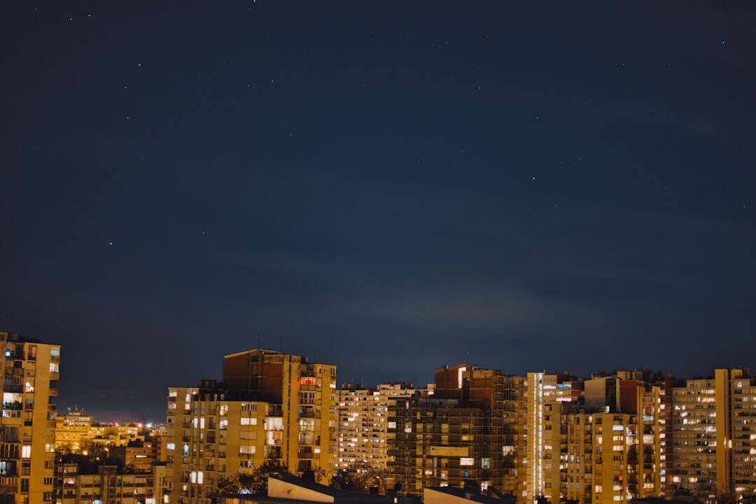 Dark atmospheric book cover artwork showing a silhouette of Zagreb's rooftops at night