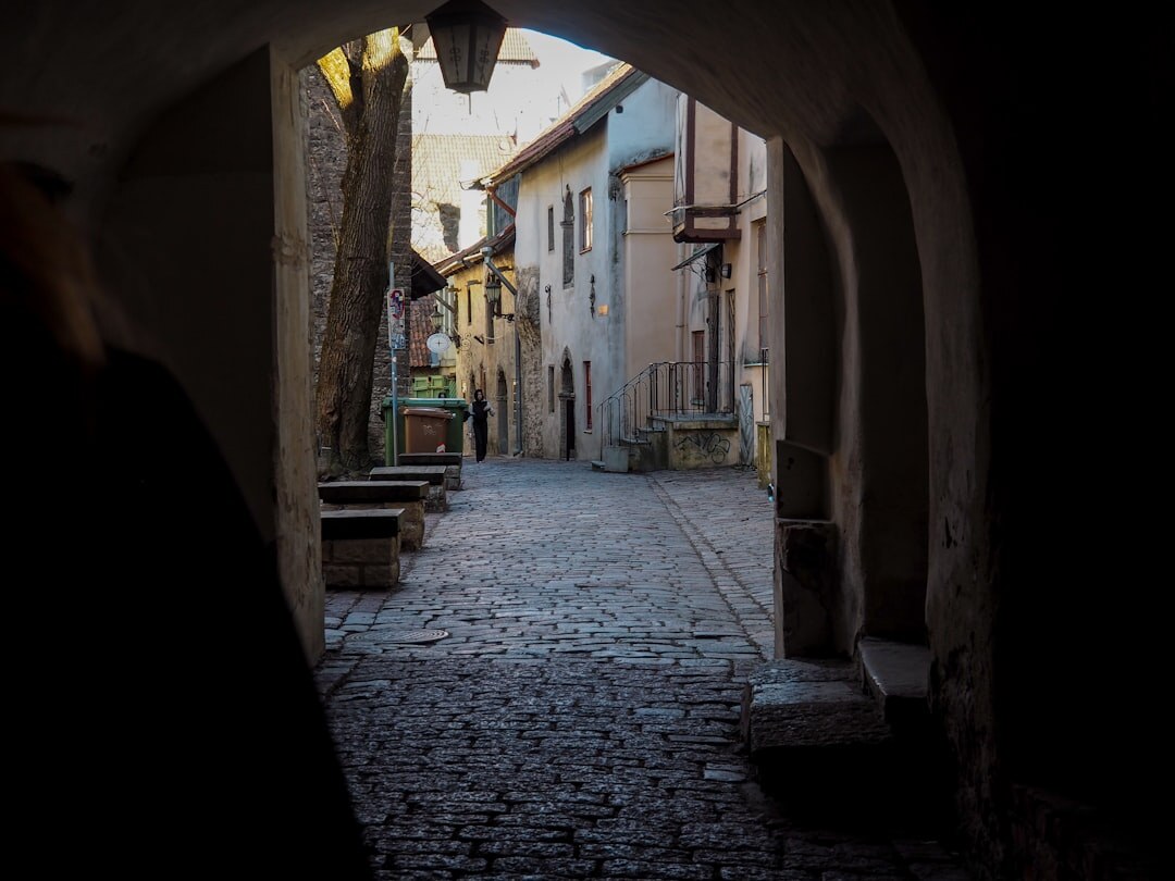 Narrow dark alley between old stone buildings in a European old town
