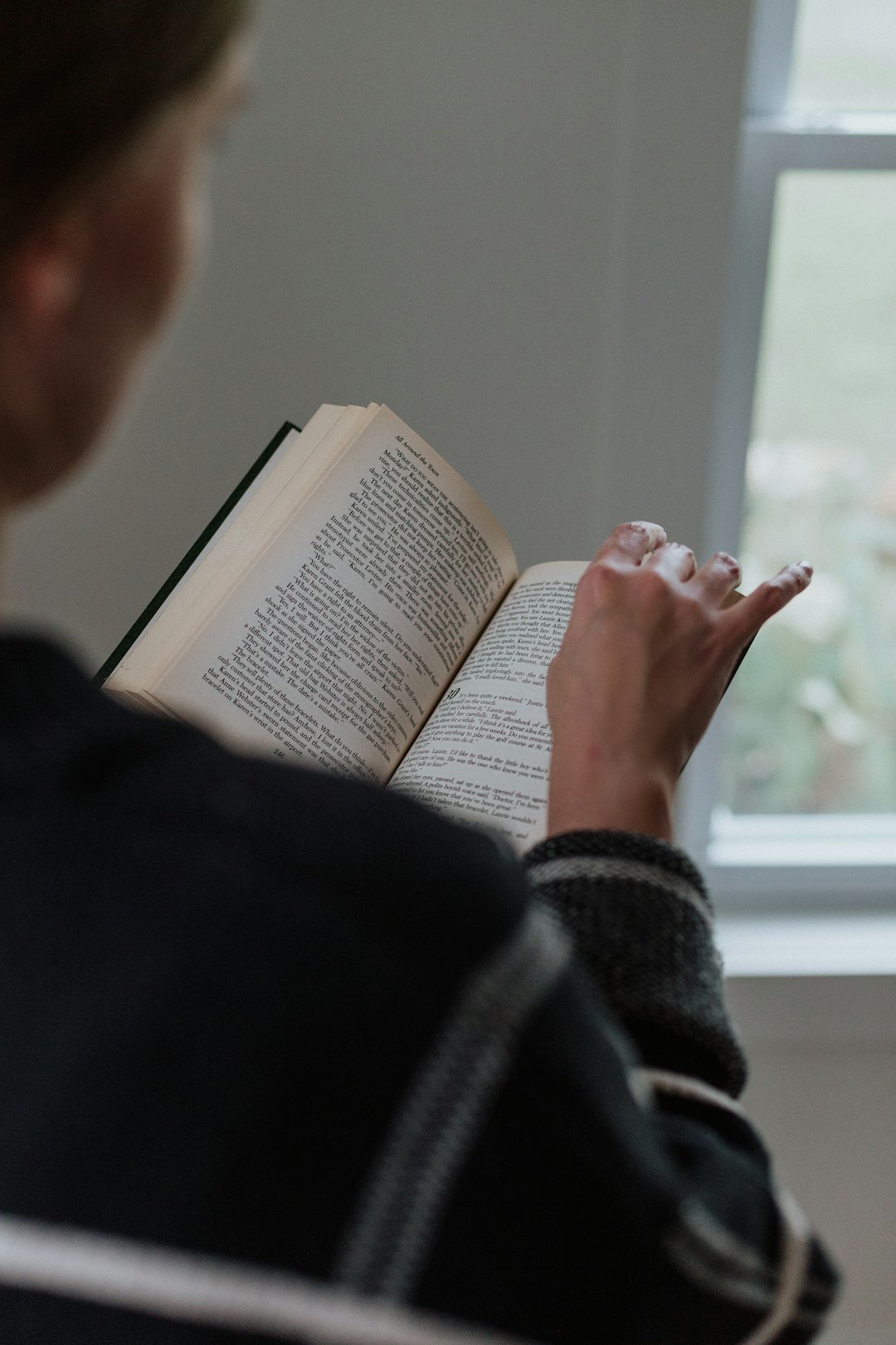 person reading thriller book